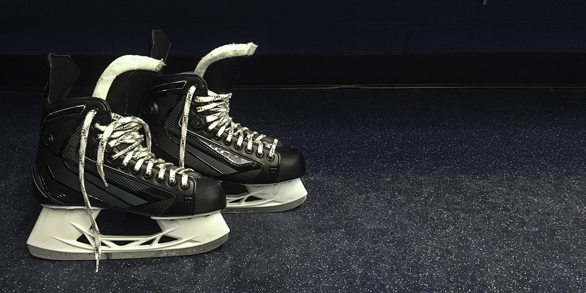 Hockey skates on rubber floor in locker room